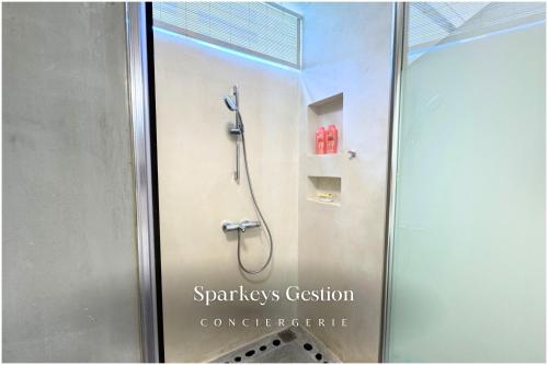a shower in a bathroom with a sign on the glass at SG14 Villa Seabreeze - seaside - lagoon view in Post of Flacq