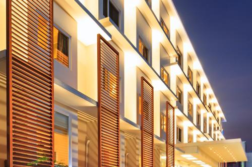 a building with lights on the side of it at Microtel by Wyndham Acropolis in Manila