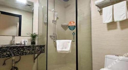 a bathroom with a shower and a sink and a toilet at GreenTree Inn Yancheng Vehicle Administrative office Test Center Express Hotel in Yancheng