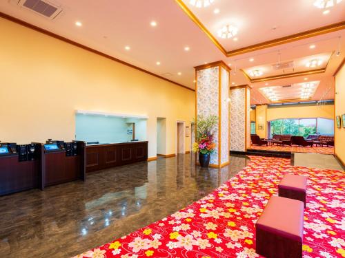 a large lobby with a large red flower carpet at BeppuOnsen Hotel Sansenkaku in Beppu