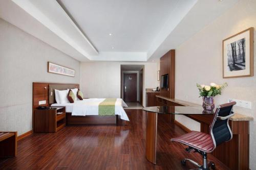 a hotel room with a bed and a desk at Yitel Collection Lianyungang High-speed Railway Station Suning Plaza in Lianyungang