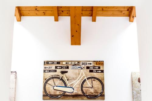 a bike on a wall next to a wooden cross at Boma Countryhouse in Casale Bufalotta