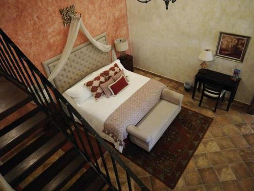 a bedroom with a bed and a chair and a desk at Hotel Casa Suwon in Suwon