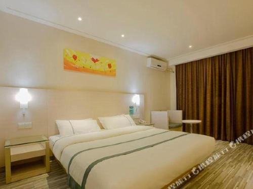 a hotel room with a large white bed in it at City Comfort Inn Nanning Zoo Keyuan Avenue in Nanning