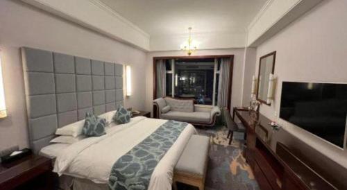 a hotel room with a bed and a television at Putian Haiyuan International Hotel in Putian