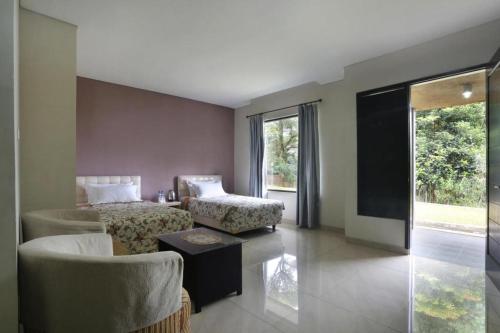 a living room with a couch and a chair at Fafa Hill Hotel and Resort in Bogor