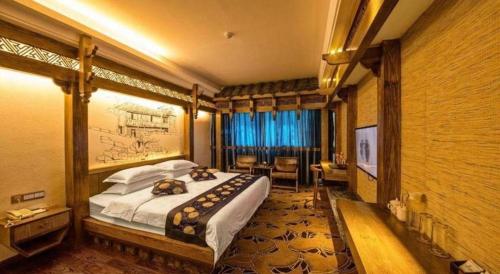 a bedroom with a large bed in a room at Zhangjiajie Xiangfu International Hot Springs Hotel in Zhangjiajie
