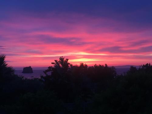 a sunset with a purple and pink sky at Villa Petrusa in Stromboli