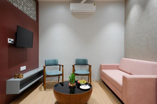 a living room with a couch and two chairs at Prarambh By Siara in Nadiad