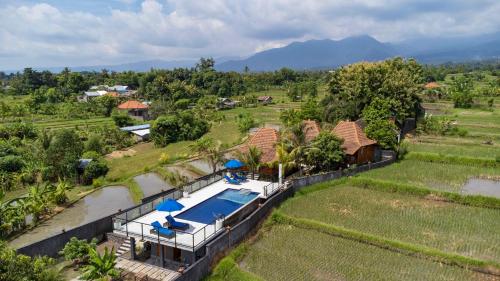 an aerial view of a house with a swimming pool at WiNy Kubu Reod in Sukasada