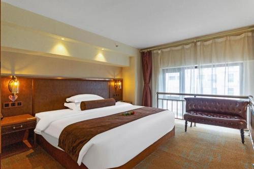 a hotel room with a large bed and a balcony at James Joyce Coffetel Xi'an Lingtong The Terracotta Army Huaqingchi University Town Metro Station in Xi'an