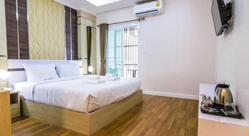 a bedroom with a large bed in a room at At Home at Udon in Udon Thani