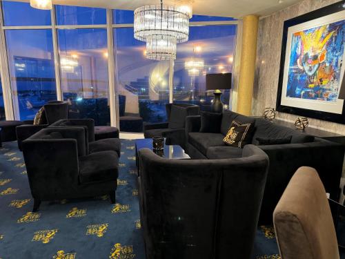 a waiting room with couches and chairs and a large window at Grand Hotel Åsgårdstrand - Unike Hoteller in Åsgårdstrand