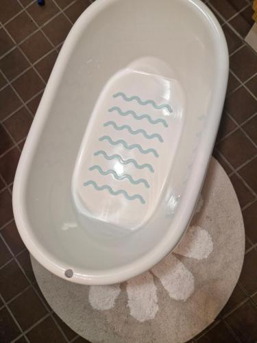 a toilet bowl with a wave painted on it at Cozy one-bedroom apartment with sauna in Rauma