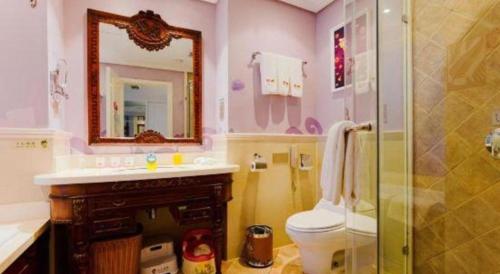 a bathroom with a sink and a toilet and a mirror at Hangzhou The First World Hotel in Hangzhou