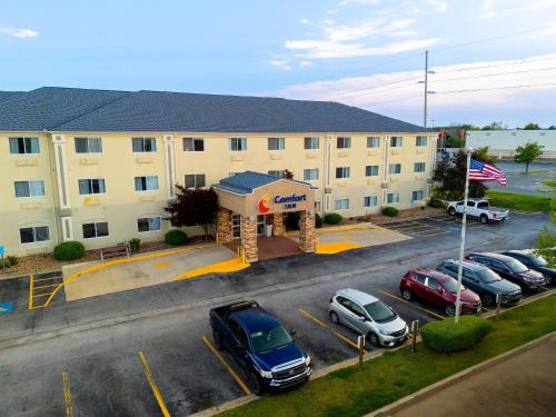 a parking lot with cars parked in front of a hotel at Comfort Inn South Tulsa - Woodland Hills in Tulsa