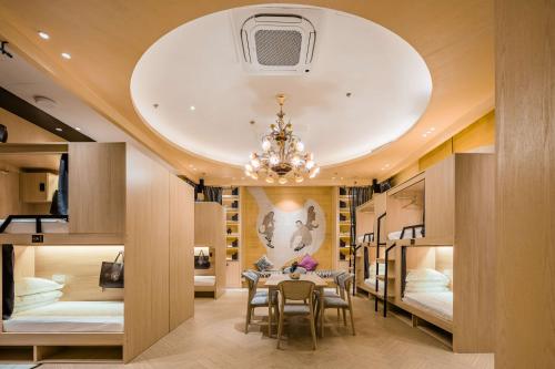 a large room with two beds and a dining table at Eastern Paris Girls' Youth Hotel in Shanghai