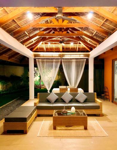a living room with a couch and a table at Halamanan Residences in Panglao