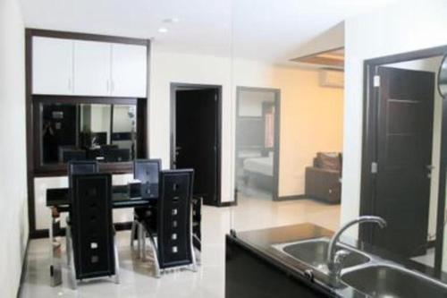a kitchen with a sink and a living room at The BCC Hotel & Residence in Nagoya