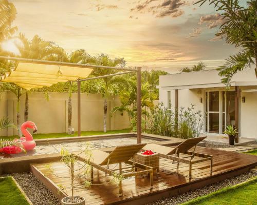 a backyard with two chairs and a table at Halamanan Residences in Panglao