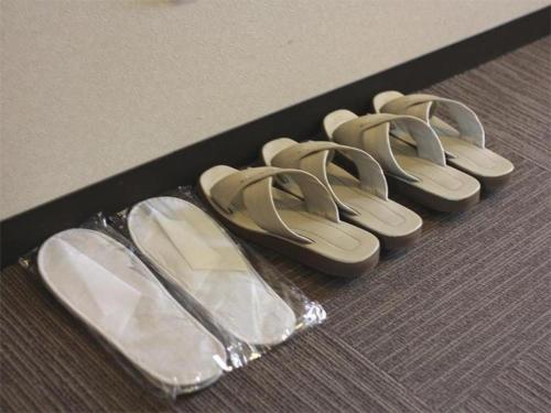 four pairs of shoes in a black box at Hotel Route Inn Furukawa Ekimae in Osaki