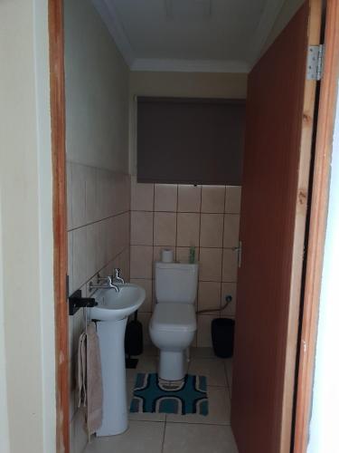 a small bathroom with a toilet and a sink at The View - Xai Xai Mozambique Xai Xai Beach Front 180 Degree Sea Views in Xai-Xai