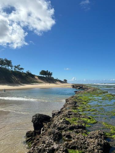a beach with a rocky shoreline and the ocean at The View - Xai Xai Mozambique Xai Xai Beach Front 180 Degree Sea Views in Xai-Xai