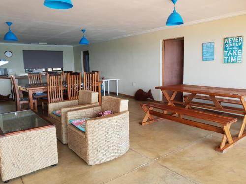 a living room with a table and chairs and a table and a dining room at The View - Xai Xai Mozambique Xai Xai Beach Front 180 Degree Sea Views in Xai-Xai