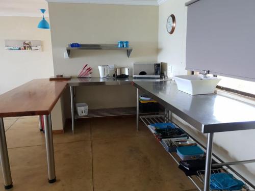 a kitchen with a counter with a sink and a table at The View - Xai Xai Mozambique Xai Xai Beach Front 180 Degree Sea Views in Xai-Xai