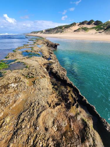 an aerial view of the ocean and a beach at The View - Xai Xai Mozambique Xai Xai Beach Front 180 Degree Sea Views in Xai-Xai