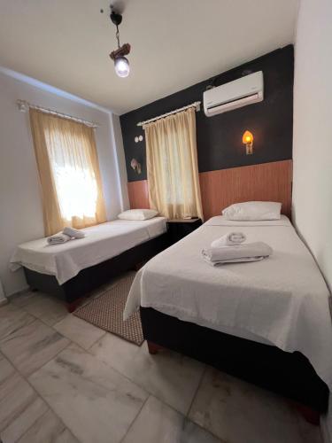 Postel nebo postele na pokoji v ubytování Kılavuz otel