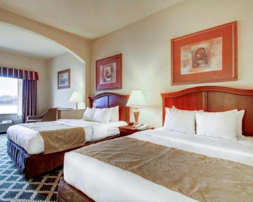 a hotel room with two beds and a window at Clarion Suites Vidalia Riverfront in Vidalia
