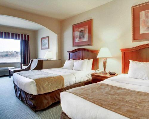 a hotel room with two beds and a window at Clarion Suites Vidalia Riverfront in Vidalia