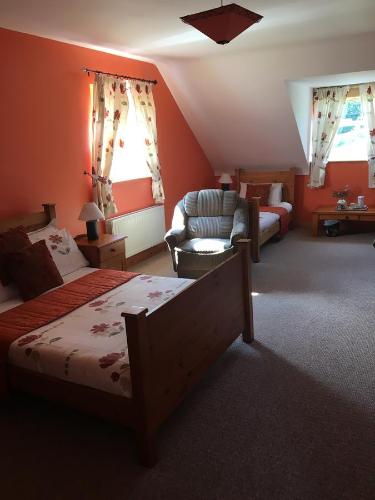 a bedroom with a bed and a living room at Heeneys Lodge B&B in Donegal