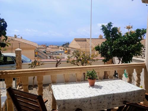 a white table and chairs on a balcony with a view at Astrid-Luise Huss in Puerto de Mazarrón