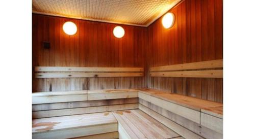 an empty sauna with wood paneling and two lights at Hotel Silk Onsen Yamabiko in Izushi