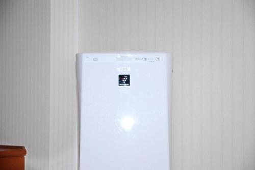 a white refrigerator with a sticker on the front of it at Albert Hotel in Akita