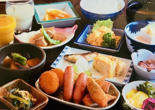 a table topped with bowls of different types of food at The Hamilton Sapporo Hotel in Sapporo