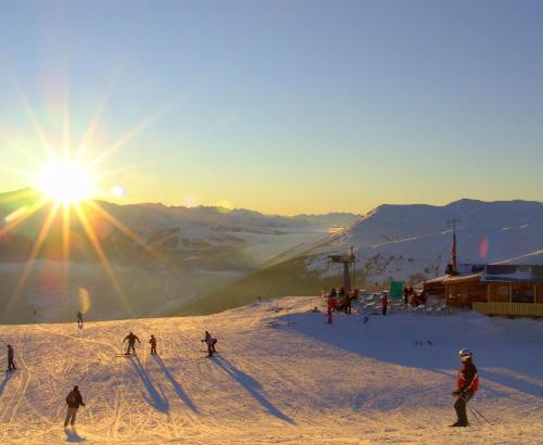 a group of people skiing down a snow covered mountain at Naturpension Mühlhof in Neukirchen am Großvenediger
