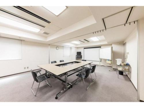 a large room with a table and chairs in it at Alpha Hotel Tokushima in Tokushima