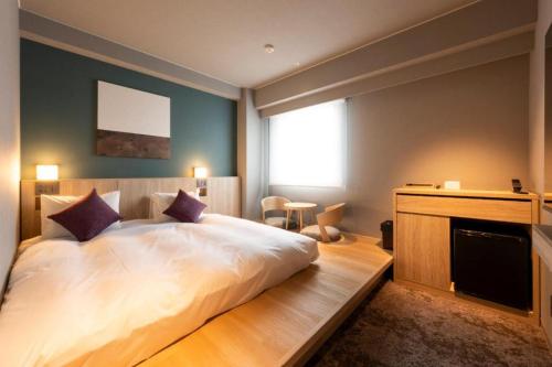 a bedroom with a large bed and a fireplace at Hotel Naito Kofu Showa in Kofu