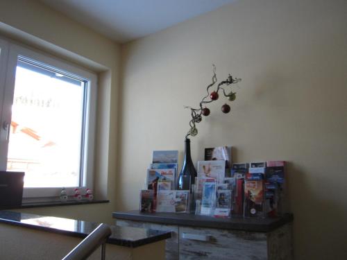 a room with a table with books and a window at Appartementhaus Gretzel in Wagrain