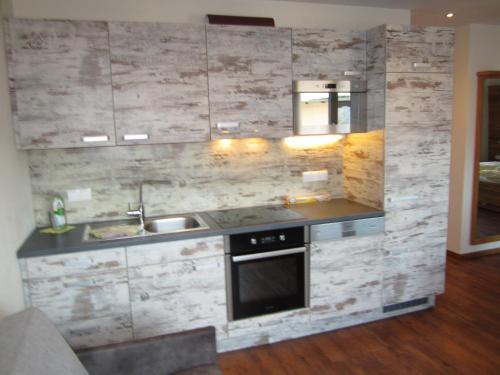 a kitchen with a sink and a stove at Appartementhaus Gretzel in Wagrain