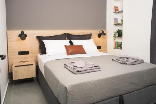 a bedroom with a bed with two towels on it at DG space 1A in Kalamata