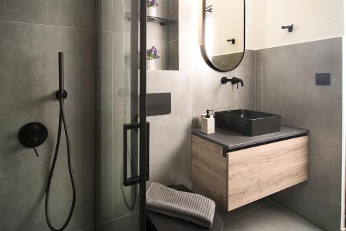 a bathroom with a sink and a shower at DG space 1A in Kalamata
