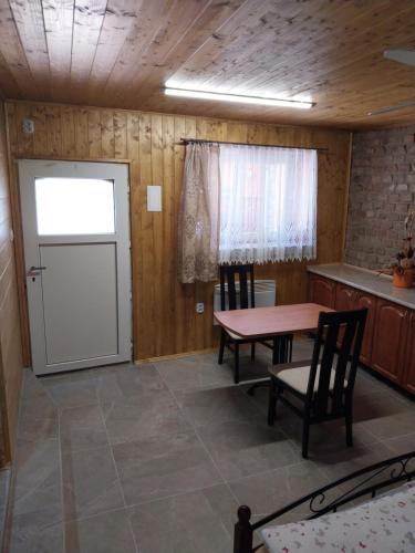 a room with a table and chairs and a door at Penzion u Šmídů Náměstí in Jaroslavice