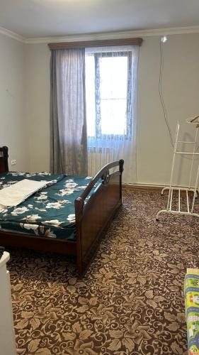 a bedroom with a bed and a window at Friend's House rooms near Airport in Yerevan