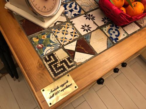 a table with a sign on top of a counter at Donna Margherita Appartamento in Naples