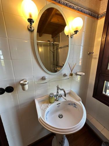 a bathroom with a sink and a mirror at Thea Thalassa in Vourvourou