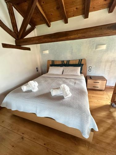 a bedroom with a bed with two towels on it at Thea Thalassa in Vourvourou
